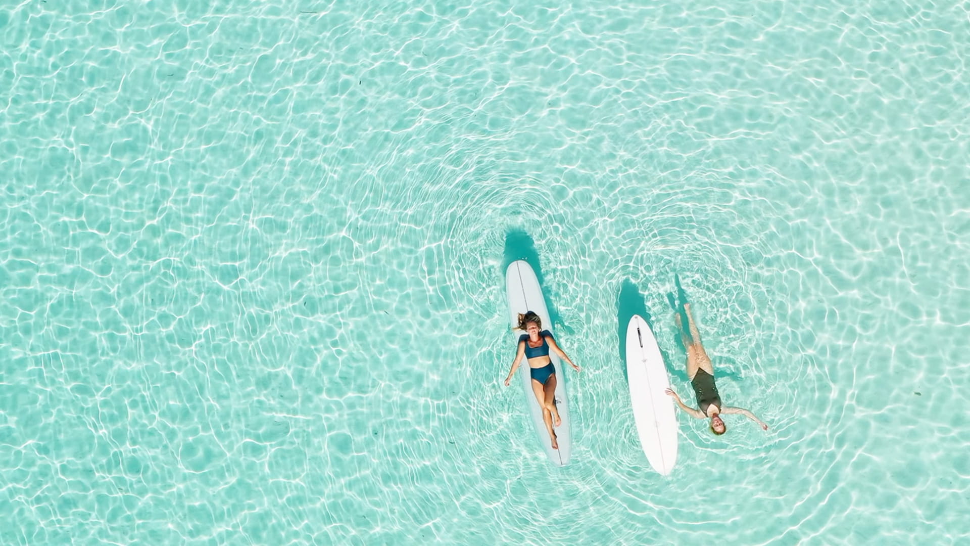 Women floating on turquoise water