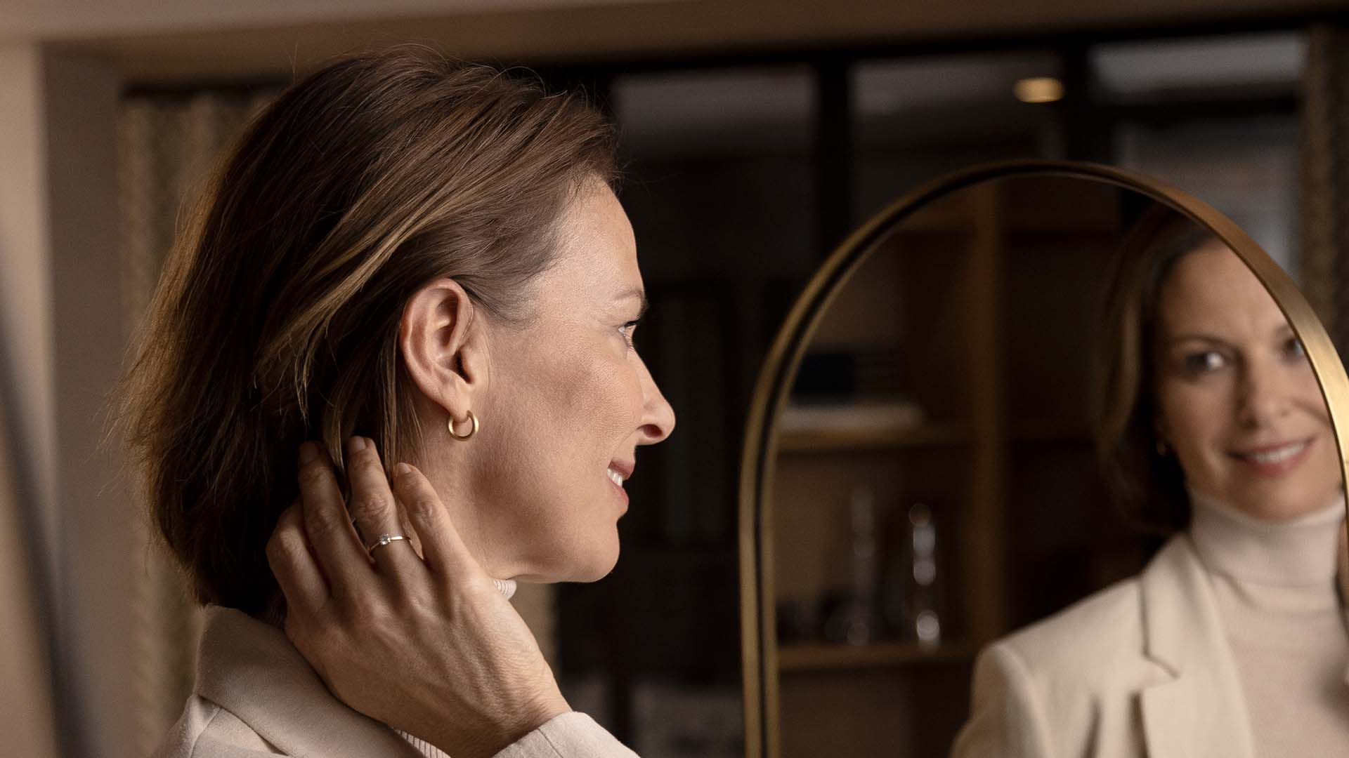 moment-sheer_mirror-woman-adjusting-hearing-aid_hero_1920x1080