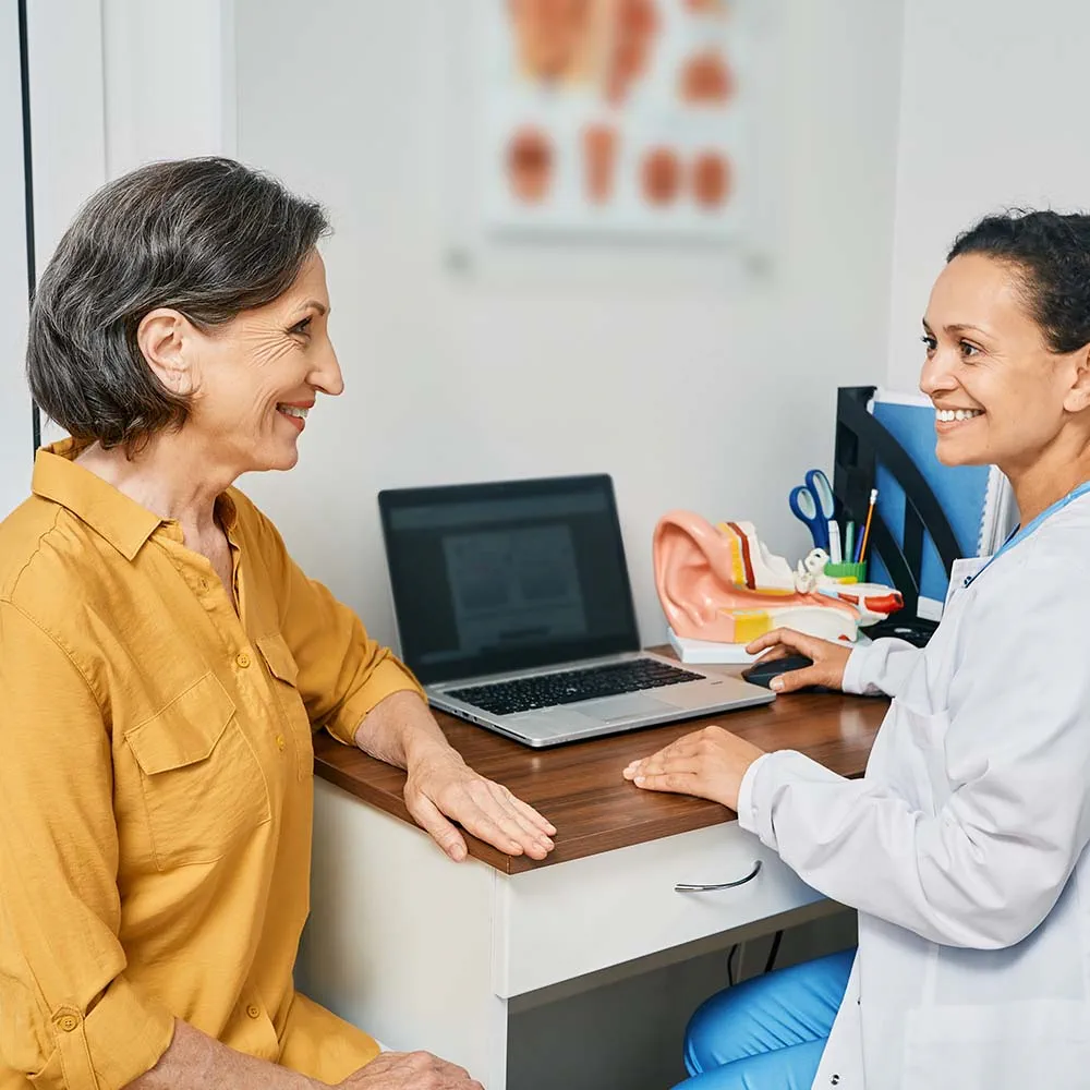 Hearing care professional talking to a patient